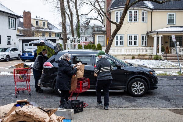 Volunteers prepare food for families in need in Newton Centre, Mass. Two federal unemployment programs are set to expire, potentially leaving millions vulnerable to eviction and hunger.