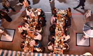 People eat at a restaurant at night in Tokyo.