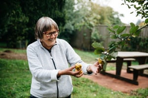 A volunteer, who describes the community of guides at Westonbirt as “like a family” shows the fruit of a quince tree