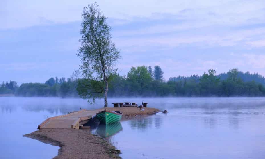 A finger island with firepit protudes into the lake.