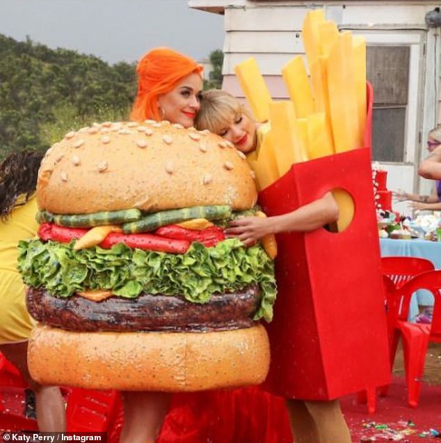 'Beef free': Katy cast Taylor in her You Need To Calm Down music video as they amicably hugged while dressed as a burger and fries while starting a new chapter of kindness and friendship moving forward; pictured June 2019