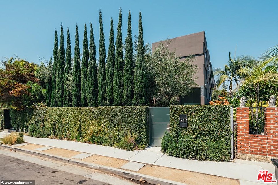 Hedges and trees surround the property maintaining privacy.