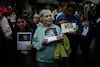 Writer and journalist Elena Poniatowska holds a photo of Regina Martínez during a 2017 protest in Mexico City calling for an end to violence against journalists.