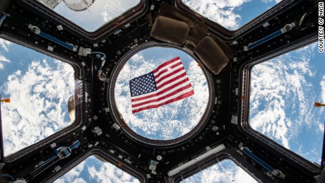 Image Kjell Lindgren released on social media of the US flag floating in the Cupola module. 