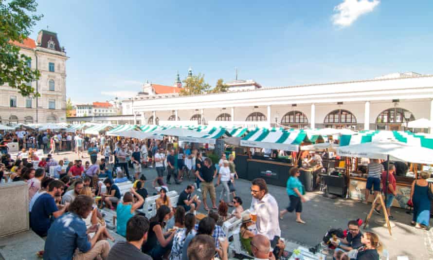 People walking and eating at a street food market, Ljubljana, Slovenia.