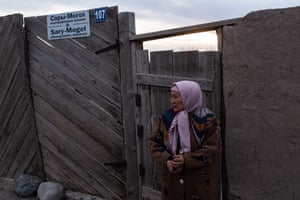 Buunisa Termechikova, 58, stands in front of the ethnic museum in Sary-Mogol