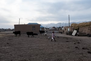 Girl carries water bottles in Sary-Mogol.