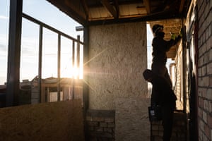 Midinov Almazbek and his brother cover the veranda with wood in Sary-Mogol.