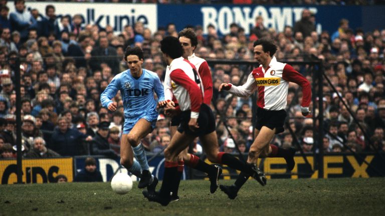 Ajax&#39;s Marco van Basten runs at the Feyenoord defence, including Johan Cruyff in an Eredivisie match between the teams in 1984