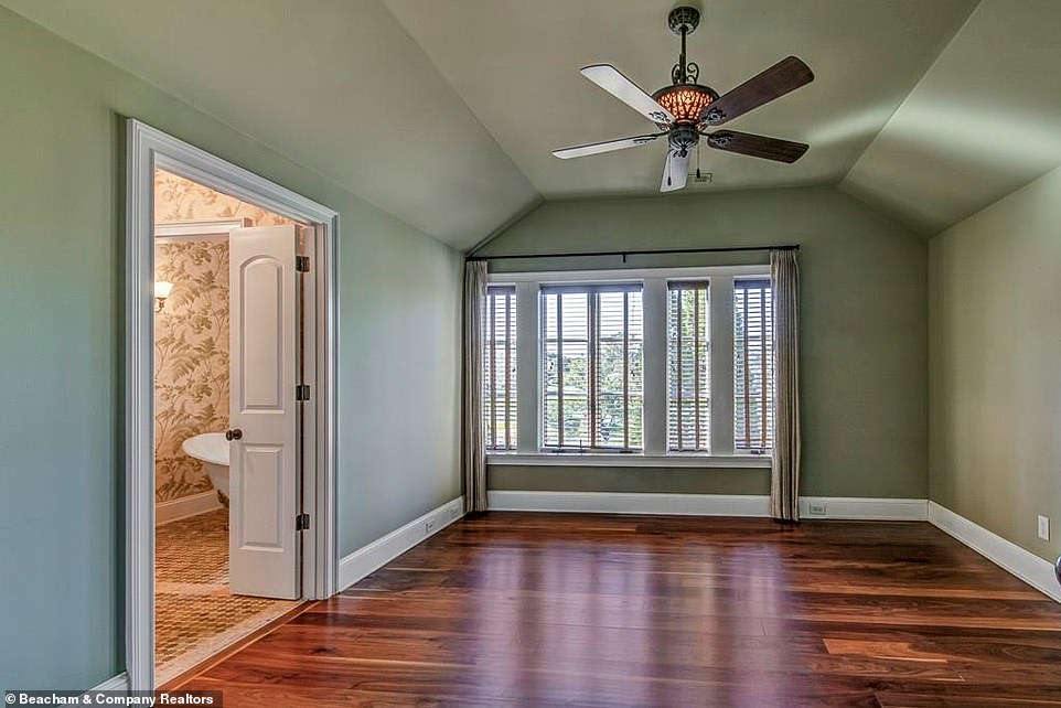 Sleek and chic: Dwayne's several bathrooms include an en-suite attached to a cozy little bedroom that has been painted in a gentle olive green shade