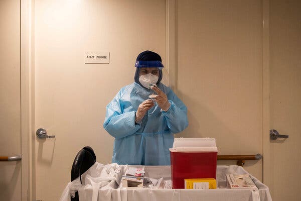 A CVS pharmacist preparing a Covid-19 vaccination for residents of a nursing home in Harlem on Friday. Nearly a third of nursing home workers in New York State have declined to be vaccinated.