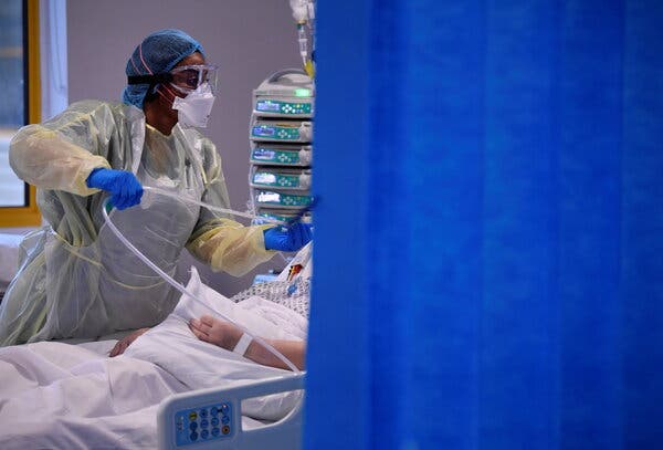 A Covid-19 patient receiving treatment on Wednesday at a hospital in Milton Keynes, England. Deaths in Britain are at their highest levels of the pandemic.