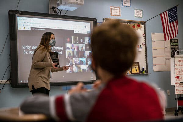 Monica Squeri teaches a reading lesson to students in her 4th Grade class while their classmates watch remotely at James Monroe Elementary School in Edison, N.J. last November. Edison is one of a few districts that elected to maintain in person instruction for students and parents who want it.