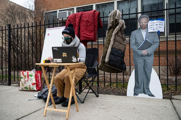 A teacher setting up her laptop outside of a Montessori elementary school in Chicago to begin virtual classes in solidarity with educators forced to teach inside the building on Monday.