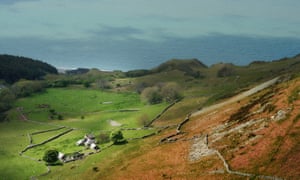 cottage on hillside with sea beyond