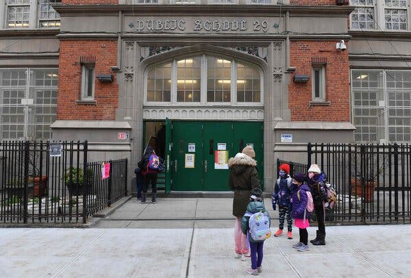 Children arrive for class on the first day of school reopening in December in Brooklyn.