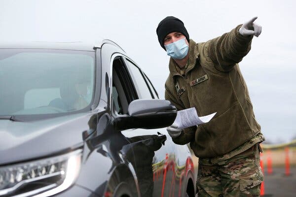 An Army National Guard specialist at one of four mass-vaccination sites opened by Washington State.