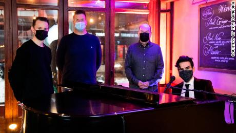 Theater producer Tom D&#39;Angora (second from left), along with his husband, Michael (far left) and performer Joe Iconis (far right) raised more than $300,000 to help save the West Bank Cafe, owned by Steve Olsen (second from right).