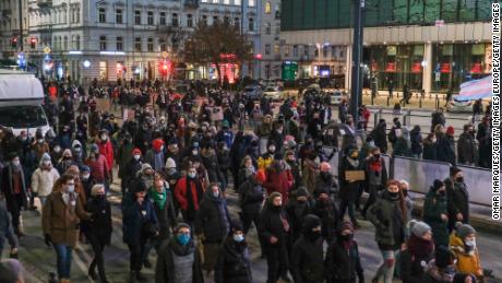 Pro-choice protesters hold banners as they march towards the Law and Justice Party Headquarters on January 27, 2021 in Warsaw, Poland.