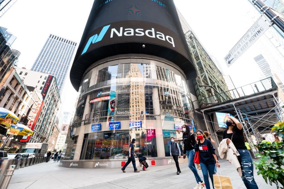 NEW YORK, NEW YORK - SEPTEMBER 22:  People wear protective face masks outside Nasdaq in Times Square as the city continues Phase 4 of re-opening following restrictions imposed to slow the spread of coronavirus on September 22, 2020 in New York City. The fourth phase allows outdoor arts and entertainment, sporting events without fans and media production. (Photo by Noam Galai/Getty Images)