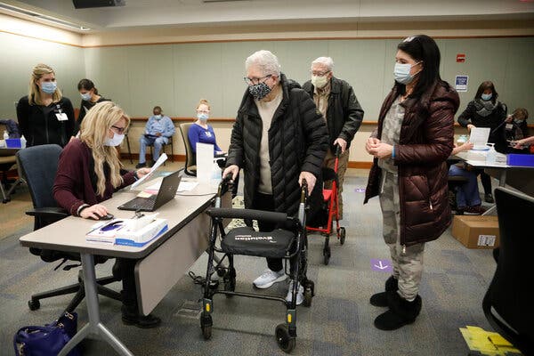 To speed up vaccination of other eligible people, some states are reallocating doses that were earmarked for nursing homes but were not being used swiftly. Jean Riordan and her husband, Joseph, both 92, prepared to be inoculated at a vaccination site in Minneapolis in January. 