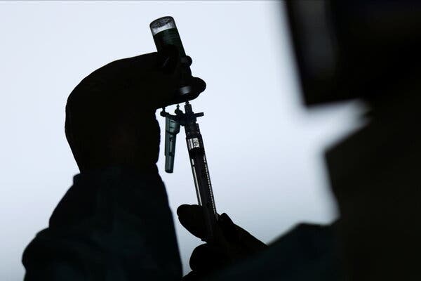 A medical worker preparing a syringe with the AstraZeneca-Oxford vaccine at a vaccination center in a public hospital in Brasilia, Brazil, on Tuesday.