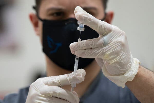 Joseph Cruz, a pharmacy manager, preparing a dose of Pfizer’s vaccine at a community center in Teaneck, N.J., last month.