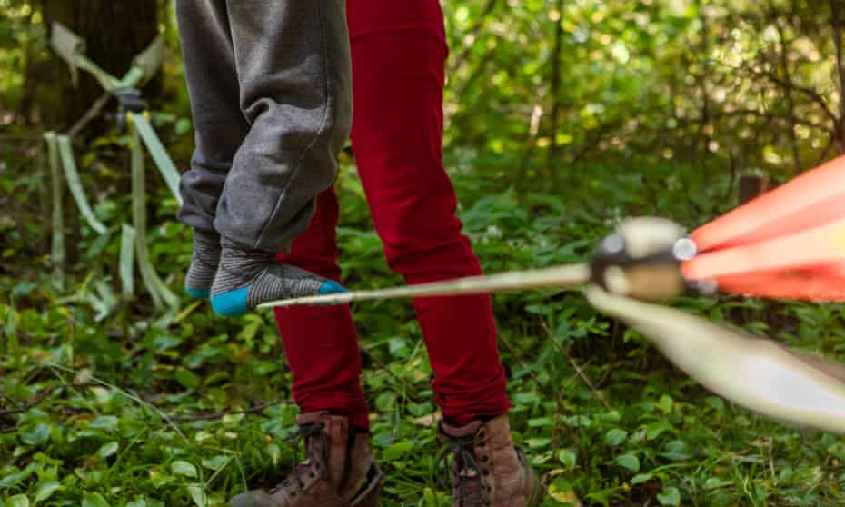 Child on slackline with parent supporting