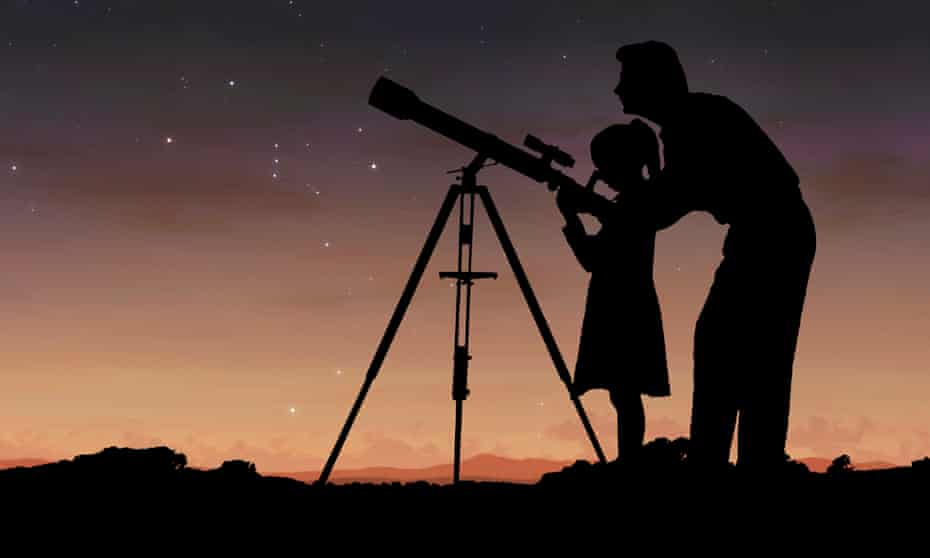 Father and daughter with telescope at night