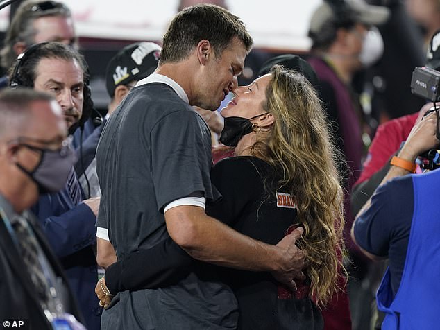 Celebratory kiss: She was also spotted celebrating the MVP with a kiss, as she and her family took to the field after the win