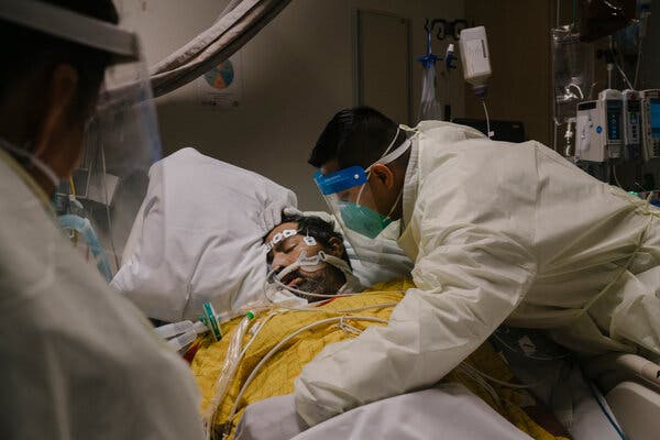 Manuel Flores, right, with his father, Gabriel, at Martin Luther King Jr. Community Hospital in Los Angeles County last month. Immediate family members are allowed to visit patients there who are believed to be near death.