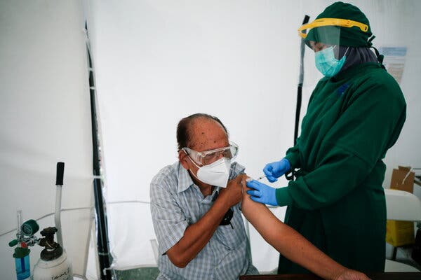 An 84-year-old doctor received his first dose of China’s Sinovac Biotech vaccine in Jakarta, Indonesia, on Monday.