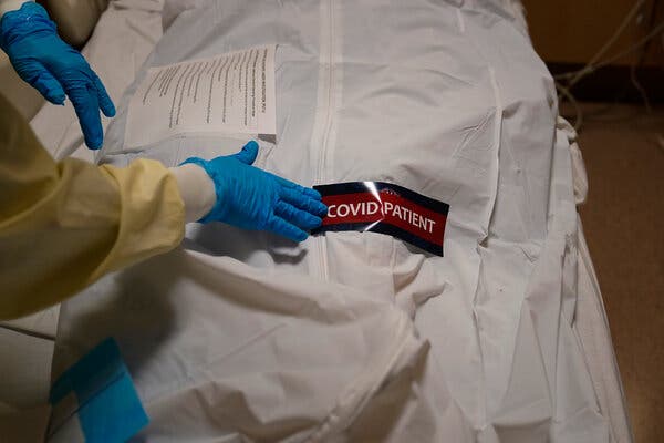 A hospital worker put a warning label on a body bag holding a deceased patient at Providence Holy Cross Medical Center in Los Angeles last month.