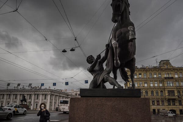 A woman walking near Anichkov bridge in St. Petersburg, Russia.