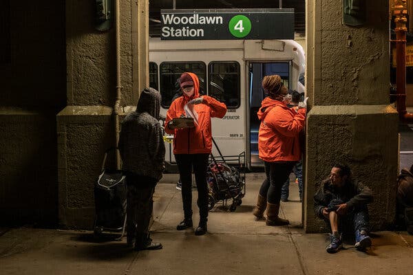 Outreach workers try to sign up homeless people to go to shelters at the Woodlawn subway station in The Bronx.