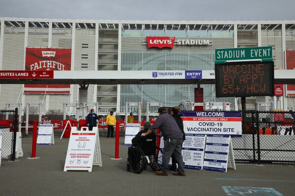 People arrive at Levi’s Stadium, a mass vaccination site in Santa Clara, Calif. 