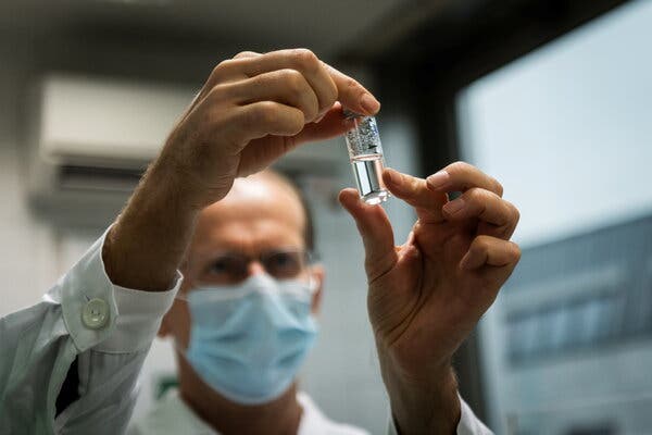 A laboratory assistant with a tube of Russia’s Sputnik V vaccine in Budapest.