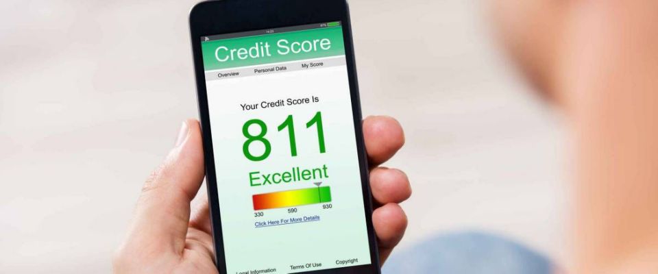 Man Holding Smart Phone Showing Credit Score Application On A Screen