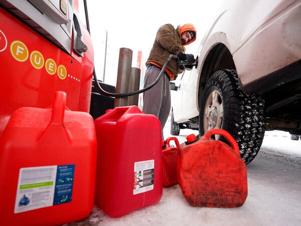 Filling a pickup truck and gas cans in Tomball, Texas, on Monday. A winter storm has disrupted energy supplies and caused widespread power outages.