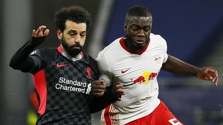 Liverpool&#39;s Mohamed Salah and RB Leipzig&#39;s Dayot Upamecano battle for the ball 