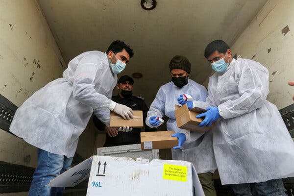 Palestinian health workers unloading the Gaza Strip’s first shipment on Wednesday.