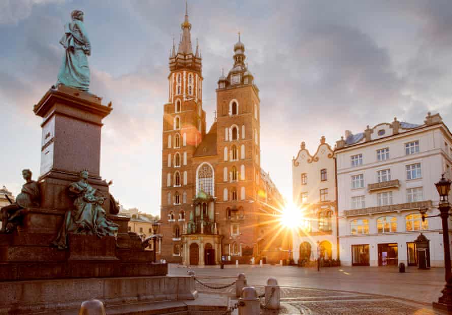 Adam Mickiewicz monument and St Mary’s Basilica in Krakow, Poland