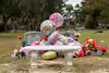 Balloons for what would have been Kimmie's 10th birthday decorate her grave this month. Her father, who died months before her, is buried alongside her. (Nydia Blas for The Washington Post)