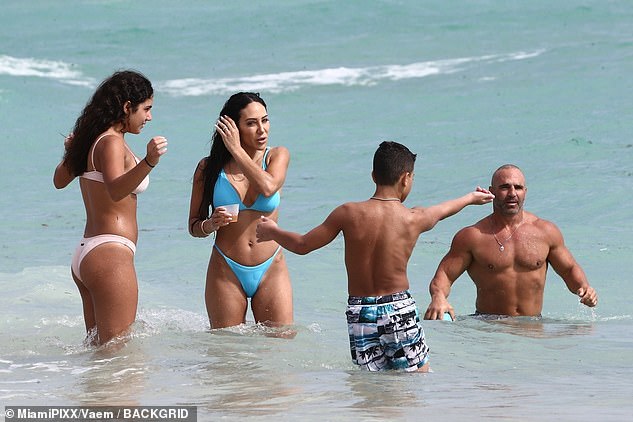 Family is everything: The family were seen staying close in the water as they cooled down