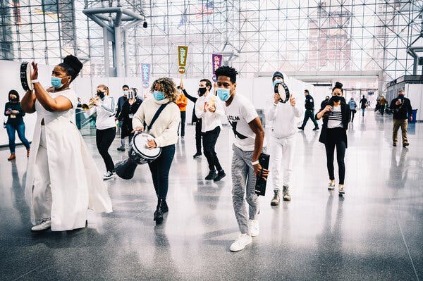 A performance by Jon Batiste, center, and his band Stay Human in New York on Saturday was the first in a series of “pop-up” shows meant to give the arts a jolt.