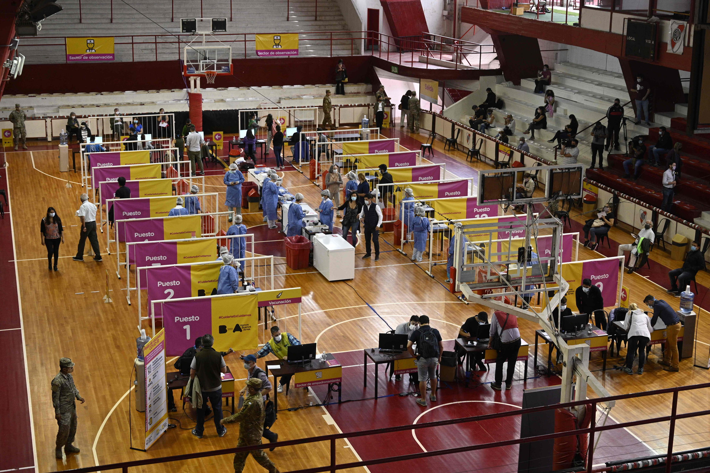 Health workers are vaccinated with the Sputnik V vaccine against COVID-19 at Argentine club River Plate's basketball court in Buenos Aires on Feb. 2, 2021.