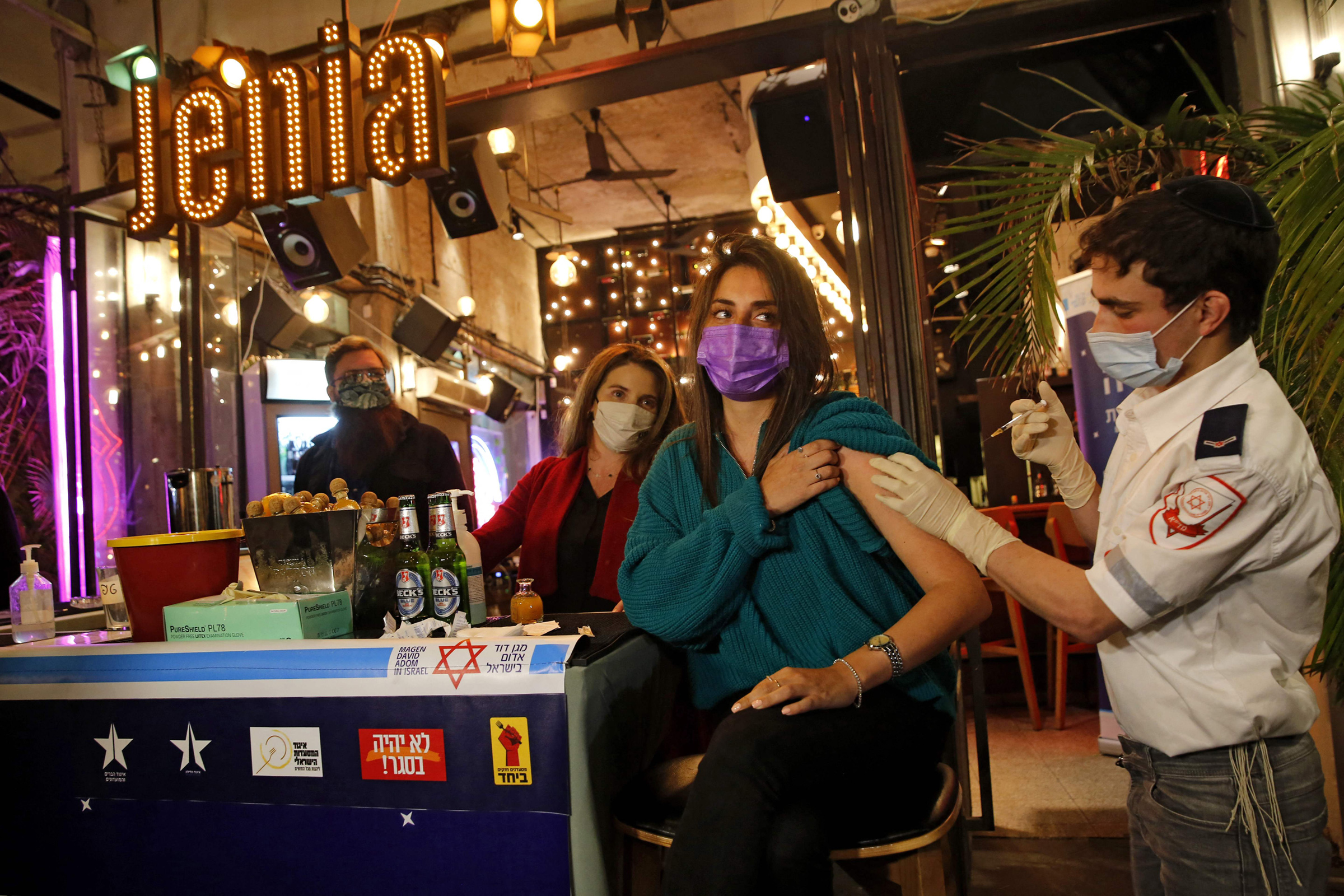 A health worker administers a COVID-19 vaccine at a bar in Tel Aviv on Feb.18, 2021.