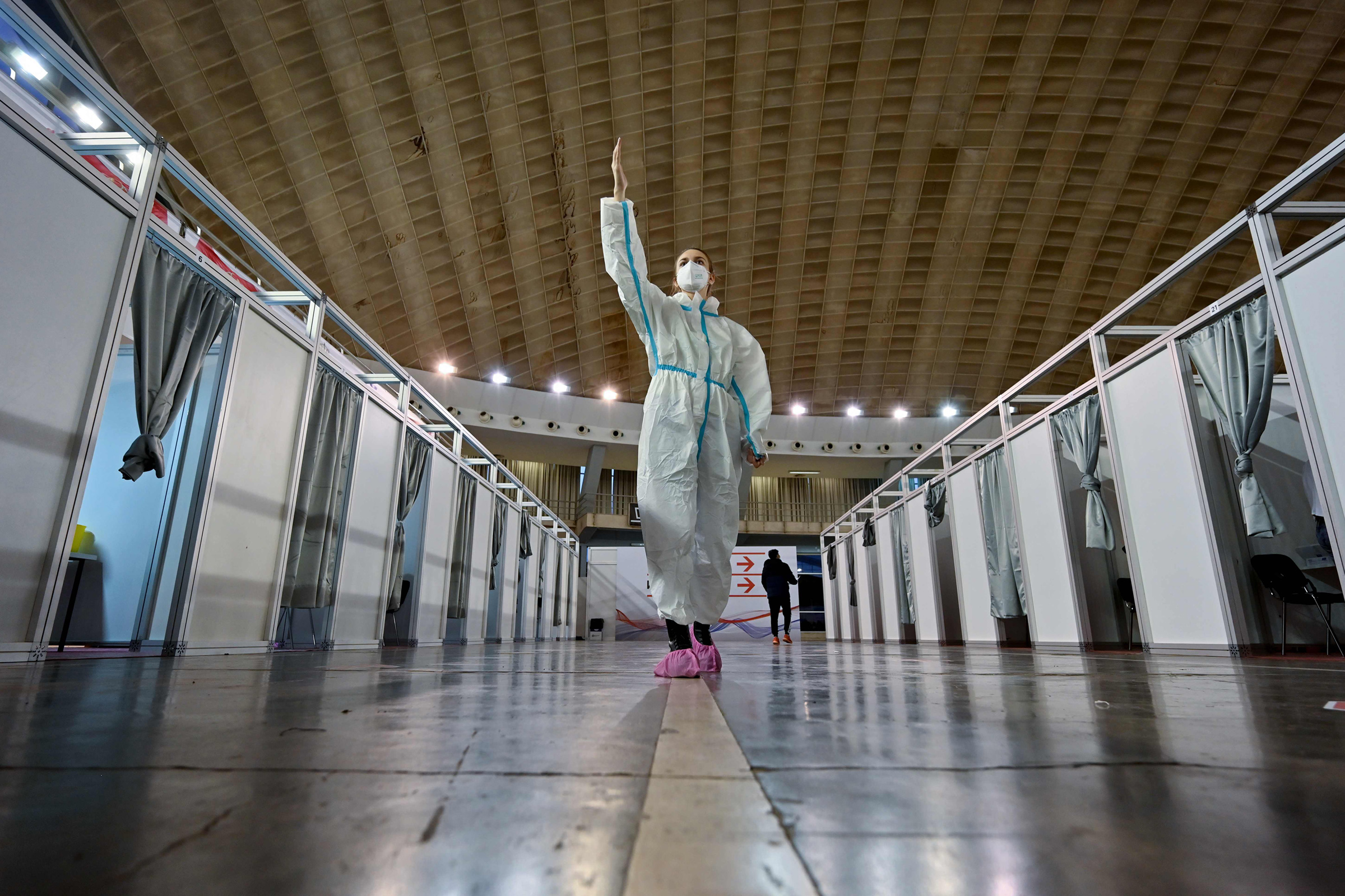 A health worker directs people arriving to get their COVID-19 vaccine at the Belgrade Fair in Belgrade, Serbia, on Jan. 25, 2021.