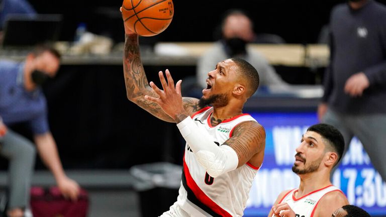 AP - Portland Trail Blazers guard Damian Lillard drives to the basket next to Denver Nuggets guard Monte Morris