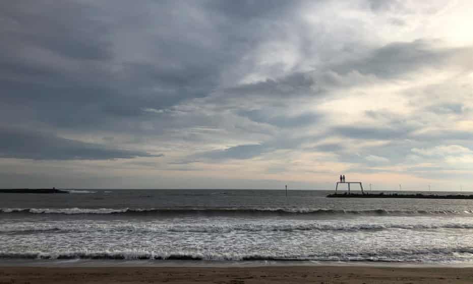 Sean Henry’s Couple sculpture in the water at Newbiggin-by-the-Sea